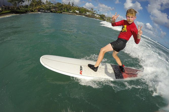 Family, Private & Group Surfing Lessons, Waikiki Courtesy Shuttle - Entering Waikiki waves with Ohana Surf Project